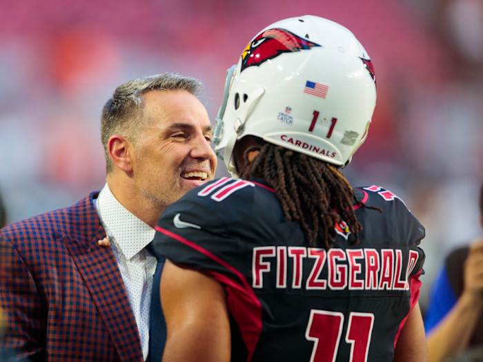 Former Cardinals quarterback and Hall of Famer Kurt Warner (left) talks with wide receiver Larry Fitzgerald prior to a 2018 game against the Broncos. Warner and Fitzgerald are the best in team history at their respective positions.